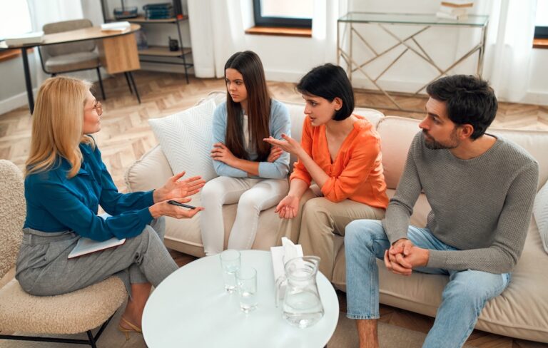A family participates in a family therapy session as part of a person's mental health treatment program.