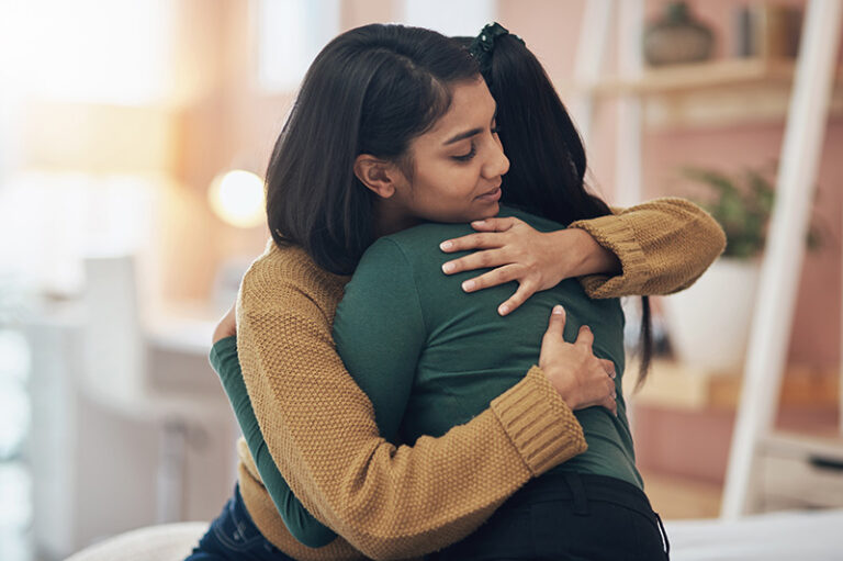 Two family members hug.