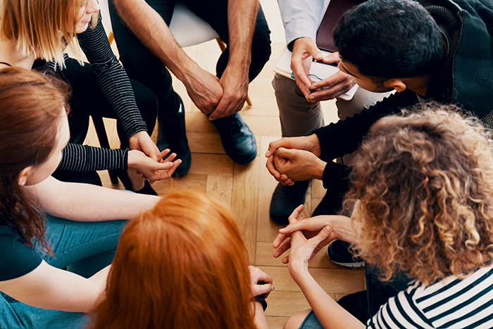 People participate in group therapy activities for anxiety.