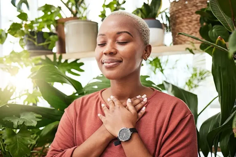 A woman practices breathwork, a technique often used in holistic mental health treatment centers.