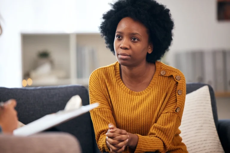 A woman talks about residential and outpatient rehab programs with a provider.