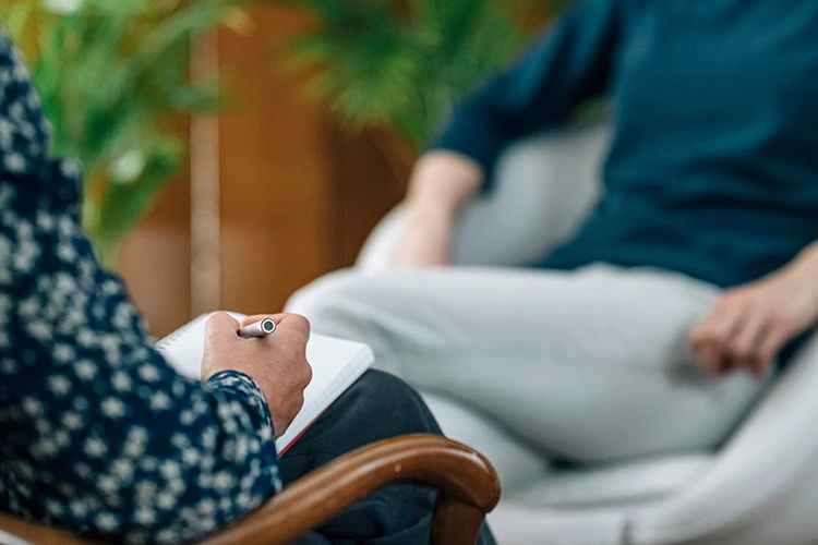 A person talks about residential and outpatient rehab programs with a provider.