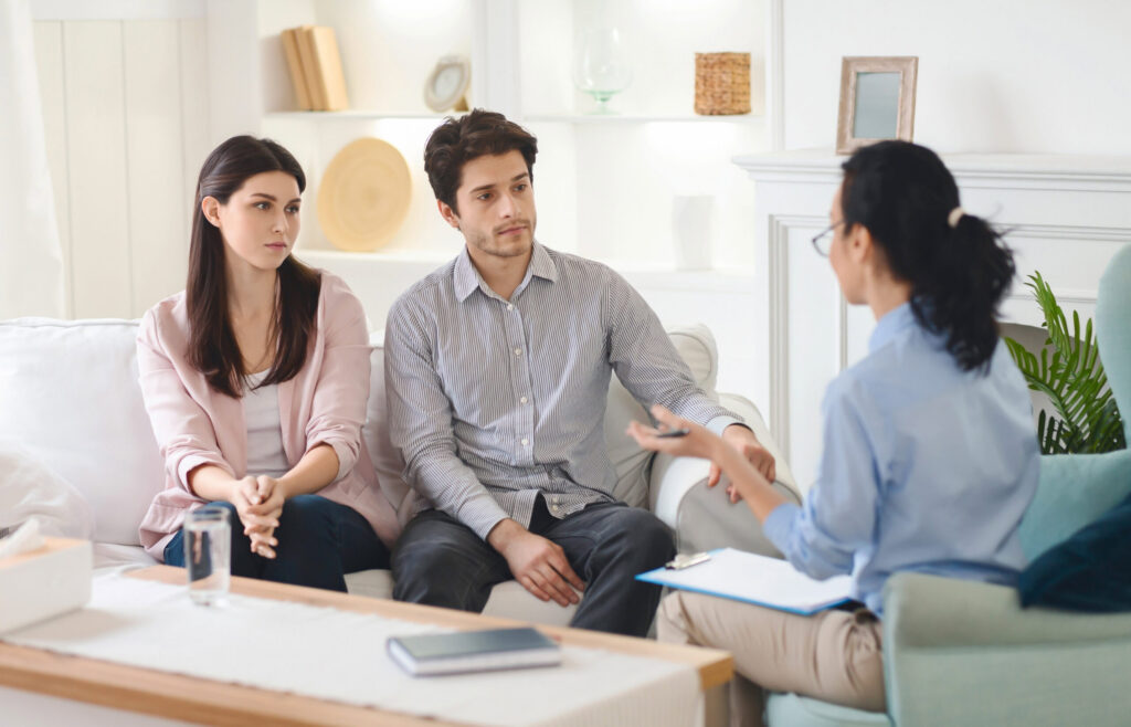 Man and woman talking to therapist about What is a Trauma Bond?