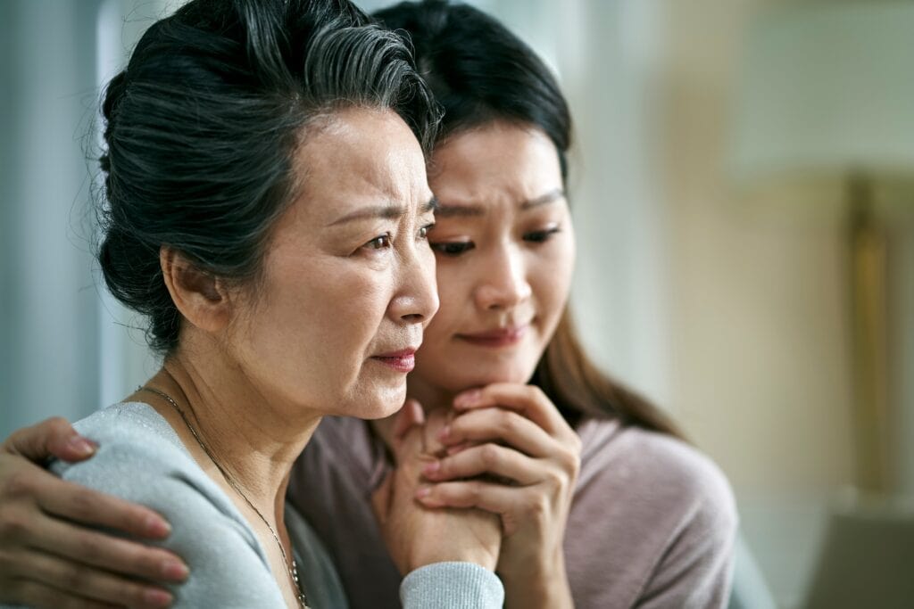 Older mother with her older daughter questioning what is intergenerational trauma?