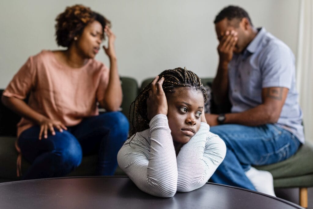 Young girl upset with arguing parents about how addiction affects families.